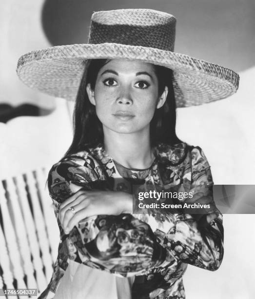 Nancy Kwan portrait wearing sun hat for the 1965 movie ' Lt Robin Crusoe, USN'.