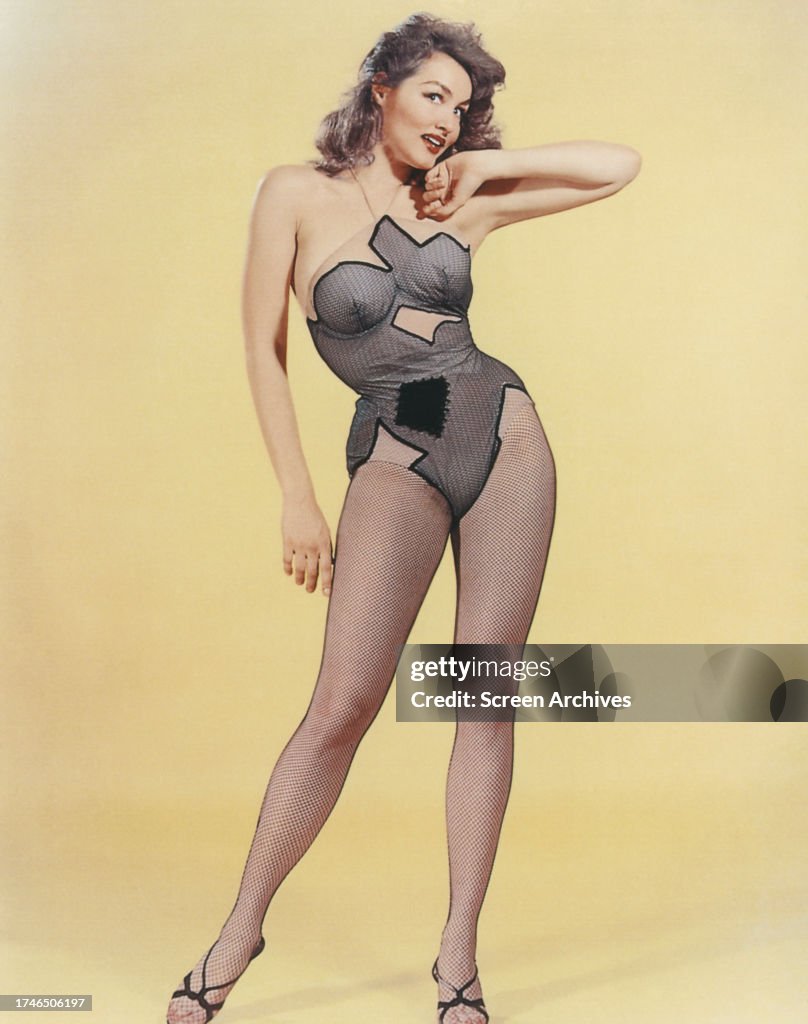 Julie Newmar poses for publicity pin up portrait wearing fishnet