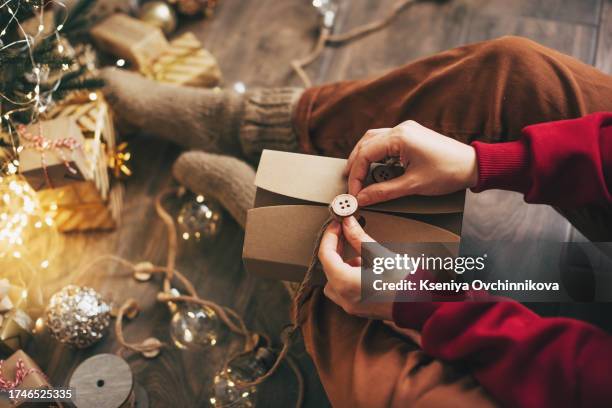 woman wrapping christmas gifts - newly industrialized country stock pictures, royalty-free photos & images