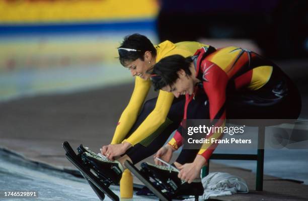 Canadian speed skater Catriona Le May Doan beside German speed skater Franziska Schenk as they secure their ice skates in the sprint competition at...