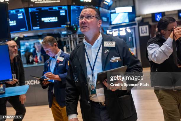 Traders work on the floor of the New York Stock Exchange on October 20, 2023 in New York City. The Dow is on a multi day losing streak as events in...