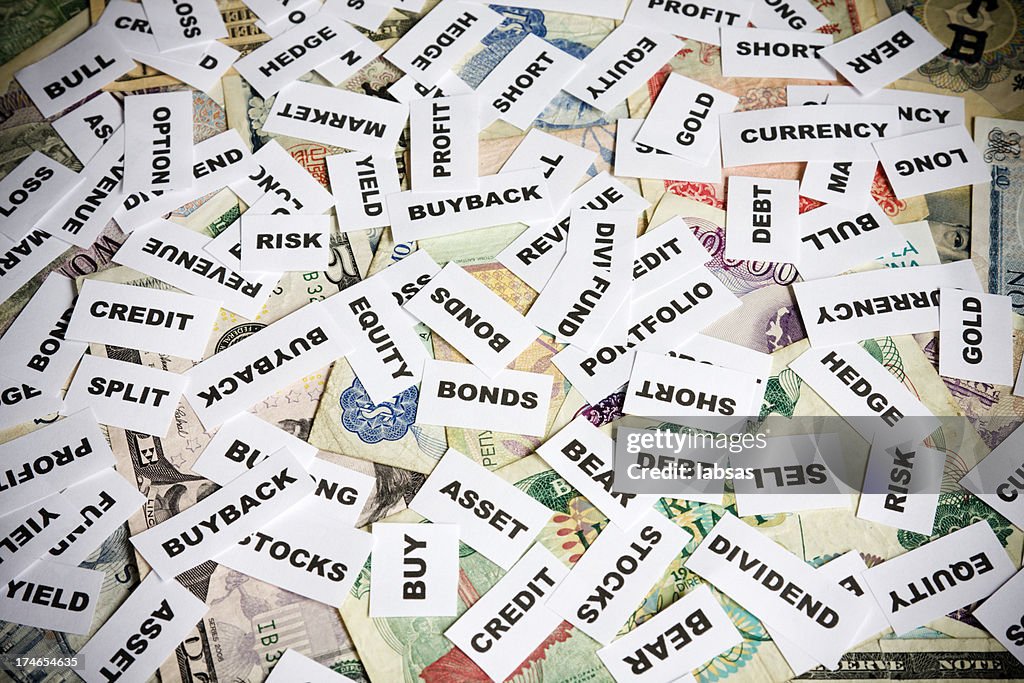 Investment terms on currency background.