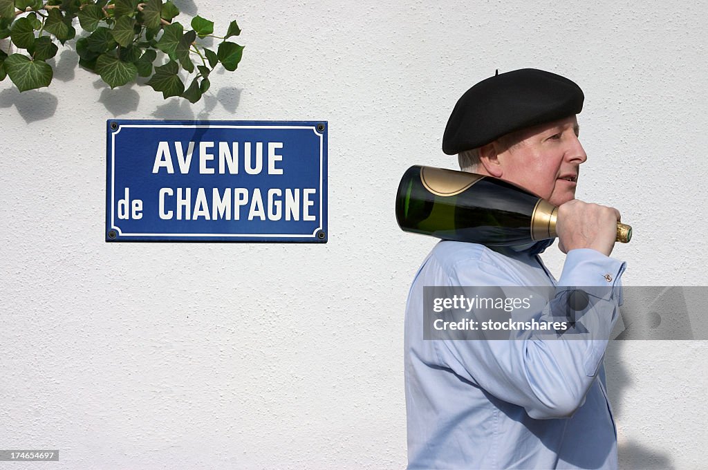 Man with Champagne passing sign saying Avenue de Champagne