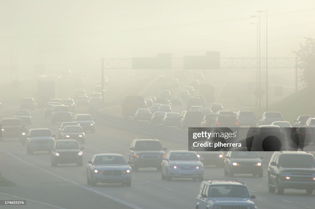 Cars at Rush Hour Driving Through Thick Smog