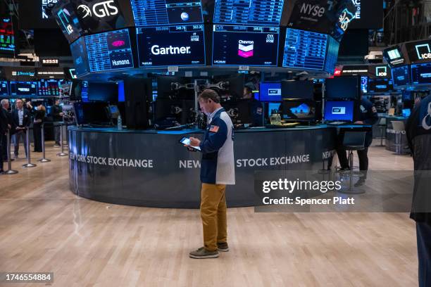 Traders work on the floor of the New York Stock Exchange on October 20, 2023 in New York City. The Dow is on a multi day losing streak as events in...