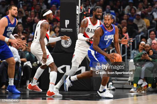 Los Angeles Clippers forward Kawhi Leonard tries to pass around Portland Trail Blazers center DeAndre Ayton during a NBA game between the Denver...