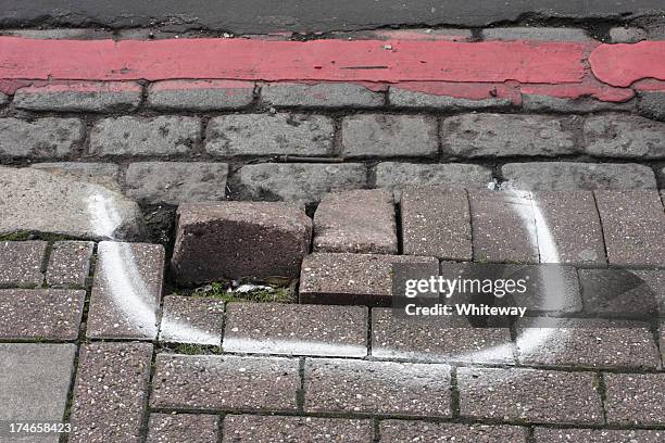 broken pavement damaged sidewalk kerb raised bricks marked for repair - sidewalk crack stock pictures, royalty-free photos & images