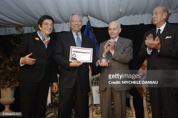Former US Secretary of State Colin Powell poses next to French former senator Anne Heinis , president of the regional general council of the Manche,...