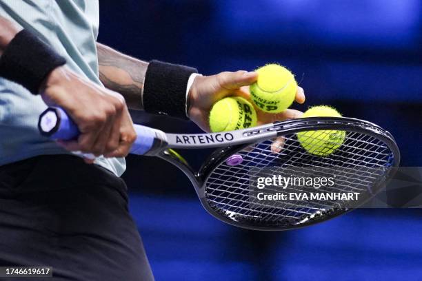 France's tennis player Gael Monfils holds a racquet and tennis balls before serving during the Erste Bank Open tennis tournament in Vienna on October...