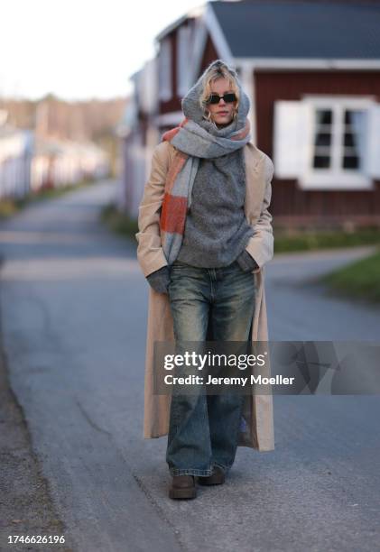 Katarina Krebs seen wearing a black sunglasses, Copenhagen Studios colorful checked wool scarf, grey wool knit pullover, beige corduroy long coat,...