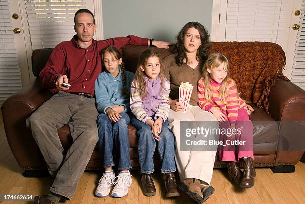 family watching tv - family sadness stock pictures, royalty-free photos & images