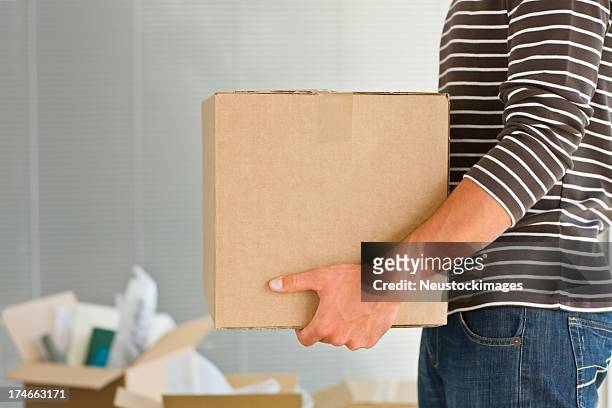 man holding box - carton box stockfoto's en -beelden