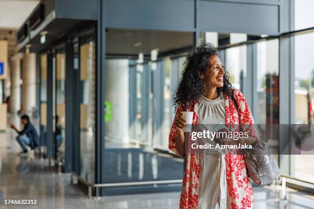 dark-skinned female happy to start a new trip at the airport - dark skin tone stock pictures, royalty-free photos & images