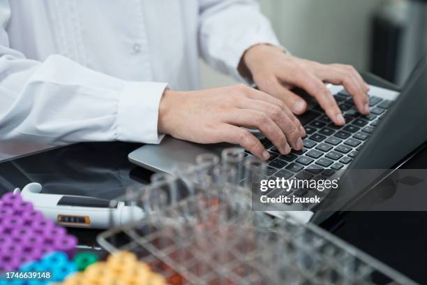 midsection of female technician using laptop at laboratory - information equipment stock pictures, royalty-free photos & images