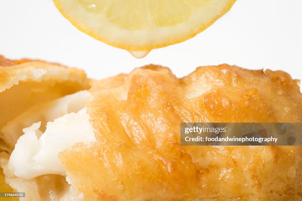 Close-up of fried fish with lemon on it