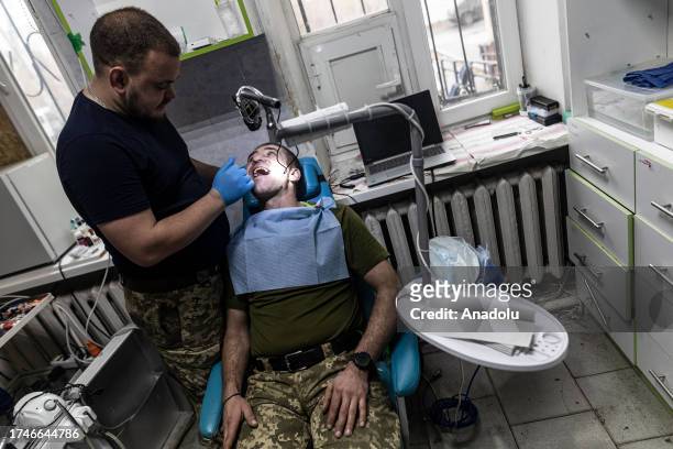 Ukrainian army dentist treats a Ukrainian soldier at a stabilization point in the direction of Donetsk Oblast, Ukraine on October 26, 2023.
