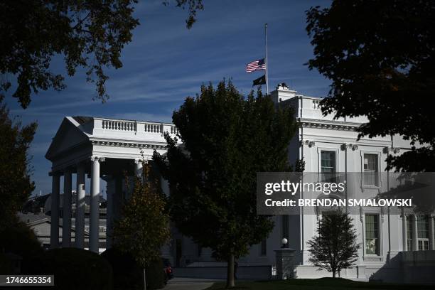 The US flag flies at half-staff atop the White House in Washington, DC, on October 26, 2023 after a gunman killed 18 people in Lewiston, Maine....