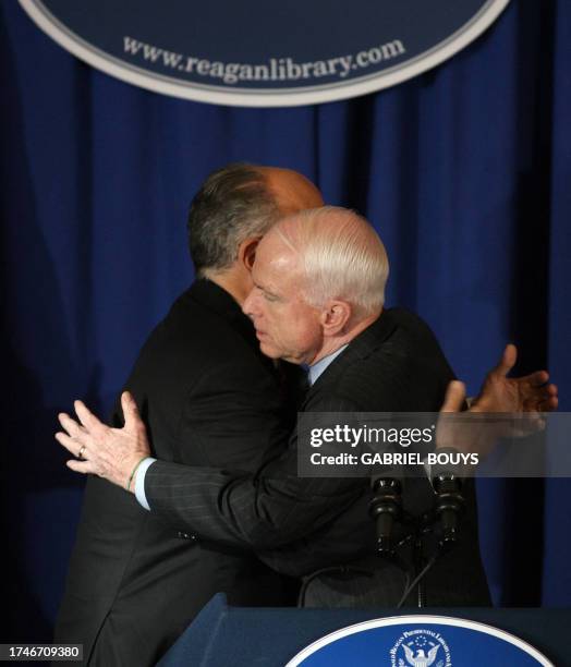 Former New York City mayor Rudy Giuliani and Arizona Senator John McCain embrace after Giuliani announced he is dropping out of the Republican...