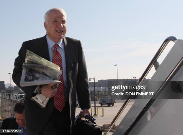 Republican presidential hopeful Arizona Senator John McCain boards his plane at Washington Dulles airport 03 February 2008 to start another day of...