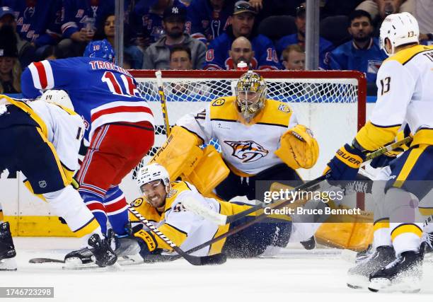 Roman Josi and Juuse Saros of the Nashville Predators defend against the New York Rangers at Madison Square Garden on October 19, 2023 in New York...