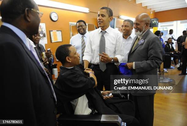 Democratic presidential candidate Illinois Senator Barack Obama greets residents while paying a visit to the Neighborhood Unisex Salon barber shop in...