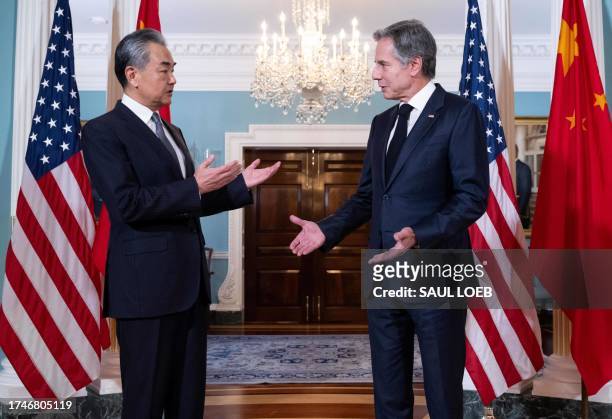 Secretary of State Antony Blinken speaks with Chinese Foreign Minister Wang Yi prior to meetings at the State Department in Washington, DC, October...