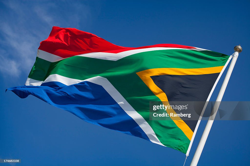 Flag of South Africa blowing in wind against blue sky