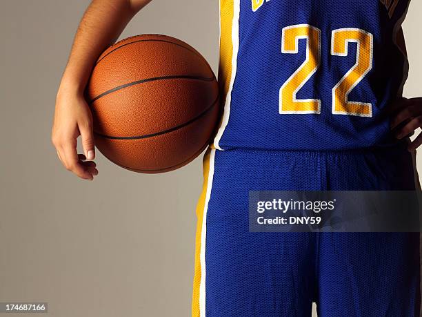 hembra high school o college basketball player retención de baloncesto - uniforme de baloncesto fotografías e imágenes de stock