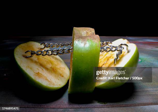 close-up of fruits on table against black background,rochester,united kingdom,uk - green apple slices stock pictures, royalty-free photos & images