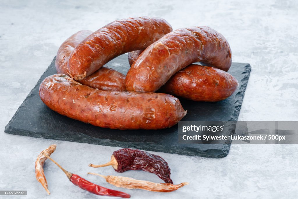 Close-up of sausages with roasted vegetables on table