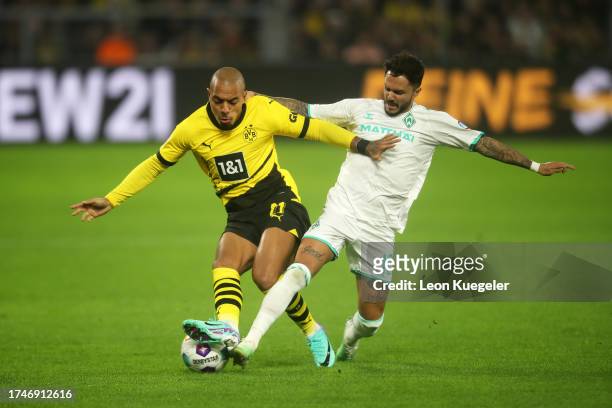 Donyell Malen of Borussia Dortmund is challenged by Leonardo Bittencourt of Werder Bremen during the Bundesliga match between Borussia Dortmund and...