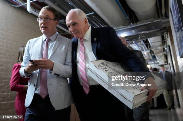 Rep. Rep. Mike Kelly carries pizza as he leaves a closed-door House Republican meeting at the U.S. Capitol on October 20, 2023 in Washington, DC. The...