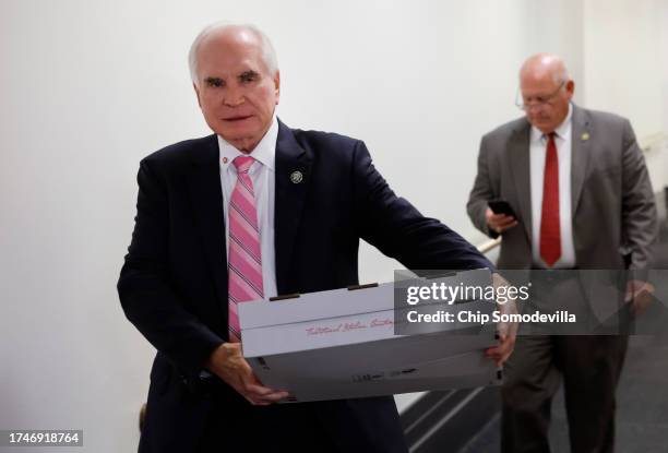 Rep. Rep. Mike Kelly carries pizza as he leaves a closed-door House Republican meeting at the U.S. Capitol on October 20, 2023 in Washington, DC. The...