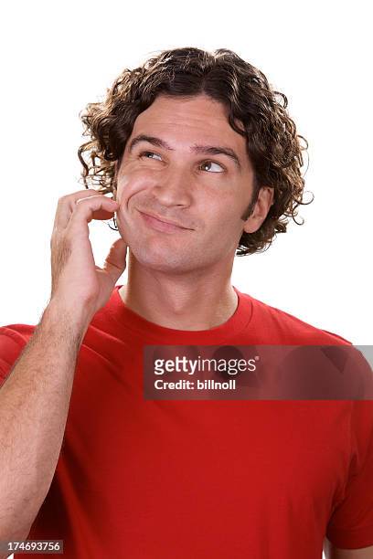 confused young male with blank red shirt - looking around on white background stock pictures, royalty-free photos & images