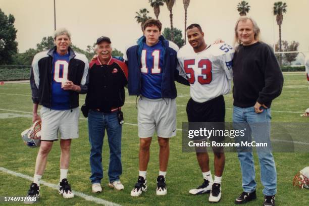 George Plimpton, Austin McCann, Drew Bledsoe of the New England Patriots, a cast member, and Joe Pytka take a break from filming on the set of a Nike...