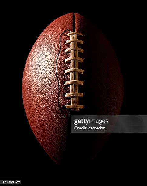 football on black - football texture stock pictures, royalty-free photos & images