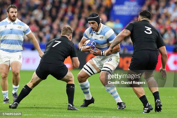 Tomas Lavanini of Argentina is put under pressure by Sam Cane and Tyrel Lomax of New Zealand during the Rugby World Cup France 2023 semi-final match...