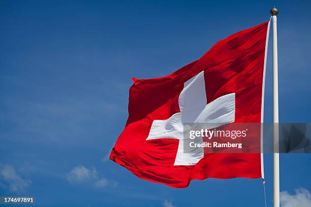 switzerland's national flag flying - switzerland stock pictures, royalty-free photos & images