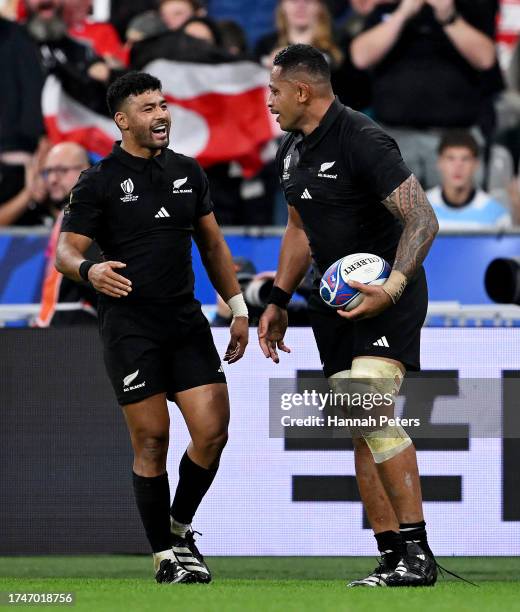Shannon Frizell of New Zealand celebrates with teammate Richie Mo'unga after scoring his team's third try during the Rugby World Cup France 2023...