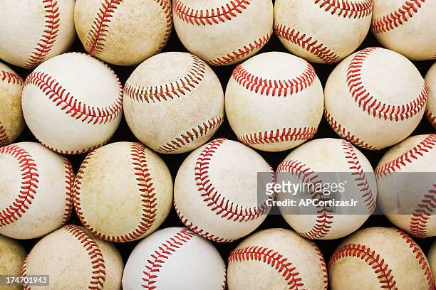 stacked rows of aged baseballs - baseball stock pictures, royalty-free photos & images
