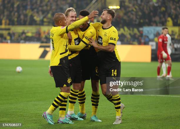 Julian Brandt of Borussia Dortmund celebrates with team mates after scoring the team's first goal during the Bundesliga match between Borussia...