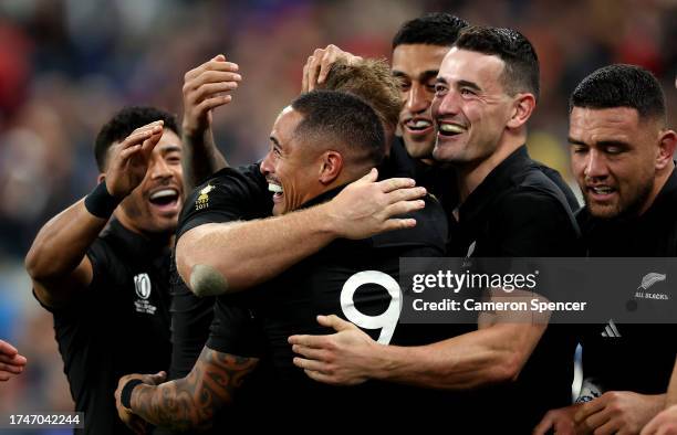 Aaron Smith of New Zealand celebrates with teammates after scoring his team's fourth try during the Rugby World Cup France 2023 semi-final match...