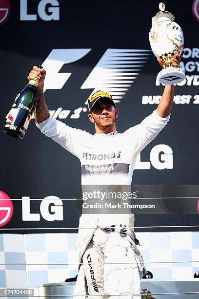 Lewis Hamilton of Great Britain and Mercedes GP celebrates on the podium after winning the Hungarian Formula One Grand Prix at Hungaroring on July...