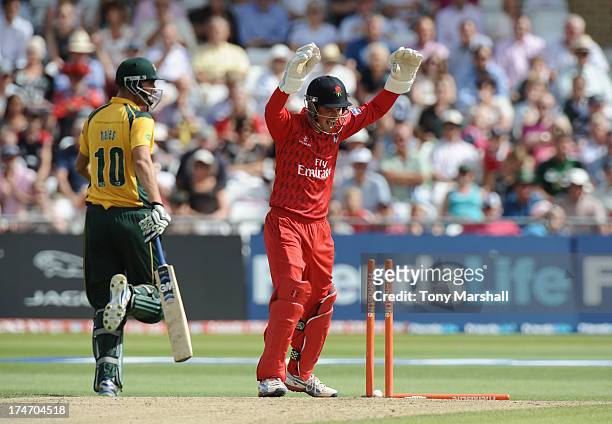 Alex Hales of Nottinghamshire Outlaws looks back as Gareth Cross of Lancashire Lightning celebrates his run out during the Friends Life T20 match...