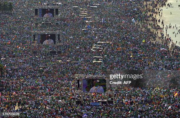 Hundreds of thousands of people crowd Copacabana beach in Rio de Janeiro on July 28, 2013 as Pope Francis celebrates the final mass of his visit to...