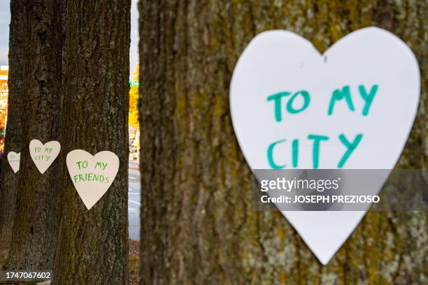 Hearts with messages are hung all over the downtown area in Lewiston, Maine on October 26 in the aftermath of a mass shootings. Hundreds of police in...
