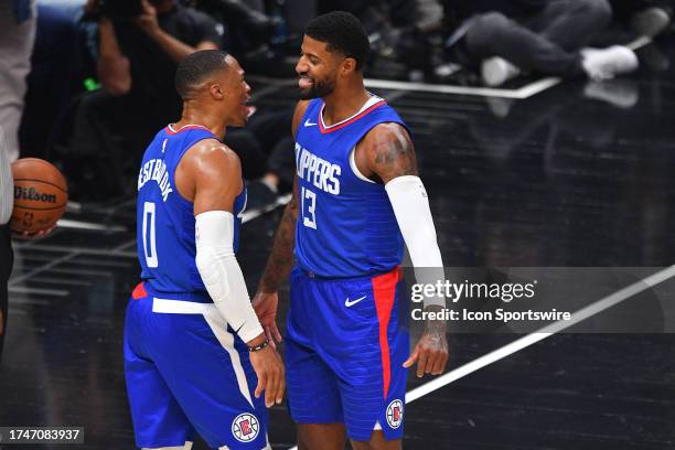 Los Angeles Clippers guard Russell Westbrook celebrates with Los Angeles Clippers guard Paul George after a dunk during a NBA game between the Denver...