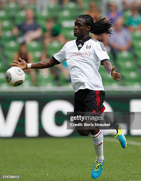 Derek Boateng of Fulham runs with the ball during the pre-season friendly match between Werder Bremen and Fulham at Weser Stadium on July 28, 2013 in...