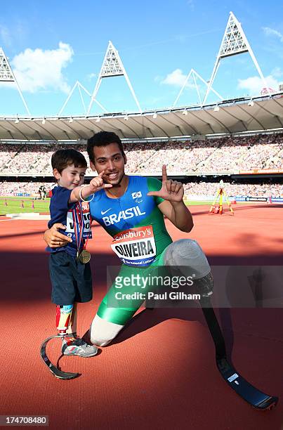 Alan Oliveira of Brazil poses with 5 year old Rio Woolf after winning the Mens T43/44 100mduring day three of the Sainsbury's Anniversary Games -...