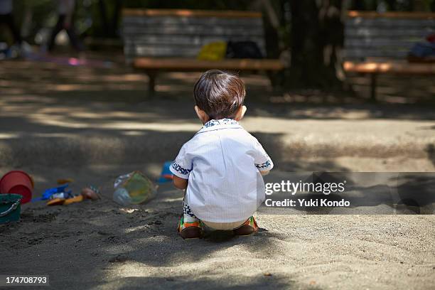 the boy who plays in a sandbox. - 2 boys 1 sandbox stock pictures, royalty-free photos & images